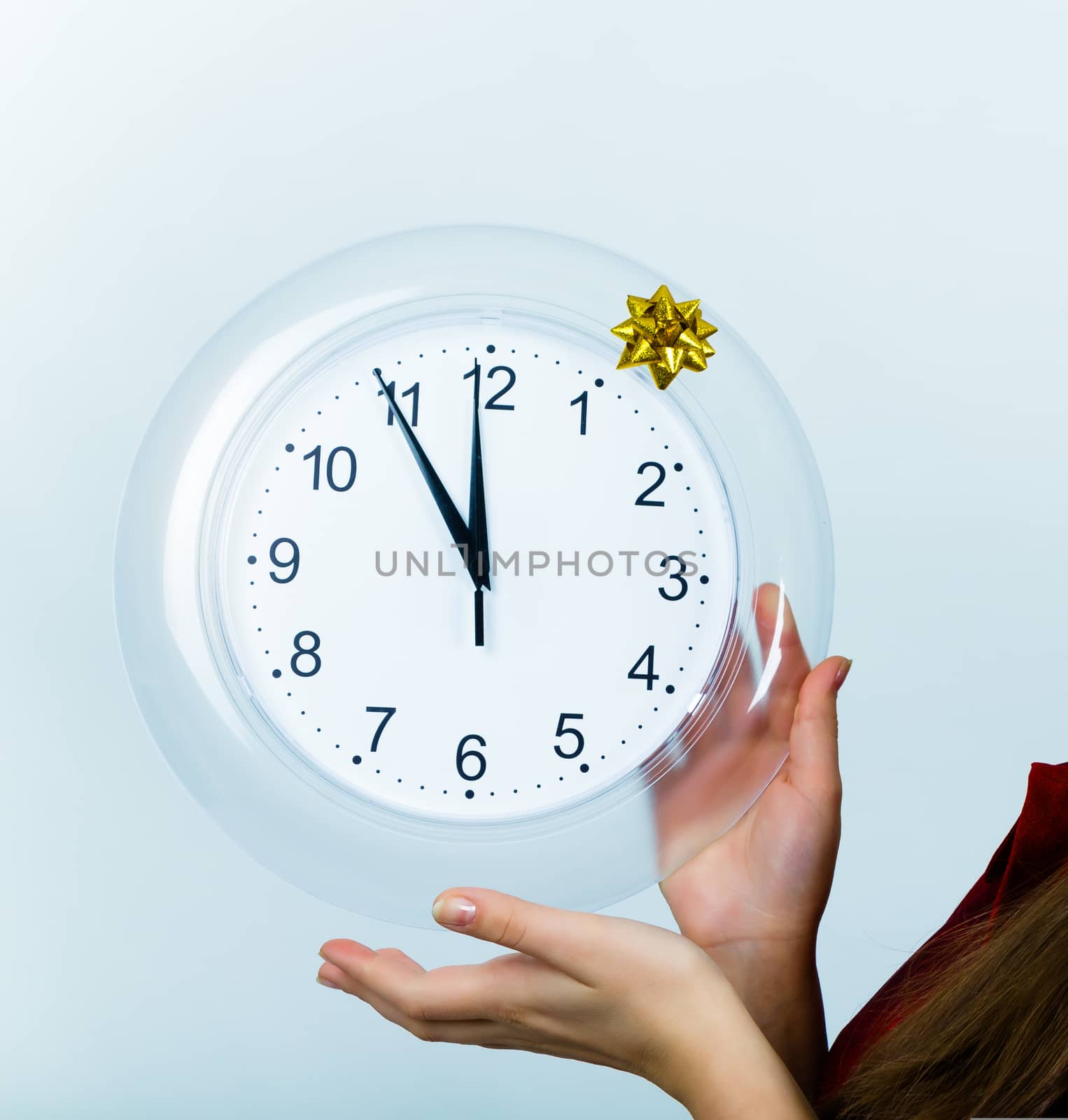 Clock showing midnight, a young female hands