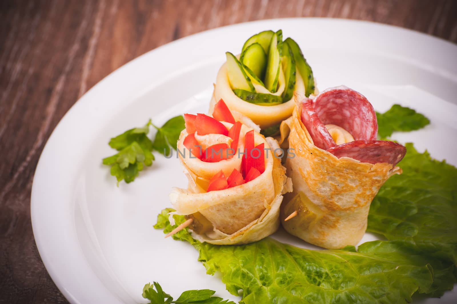 eastern european pancake rolls on white plate 