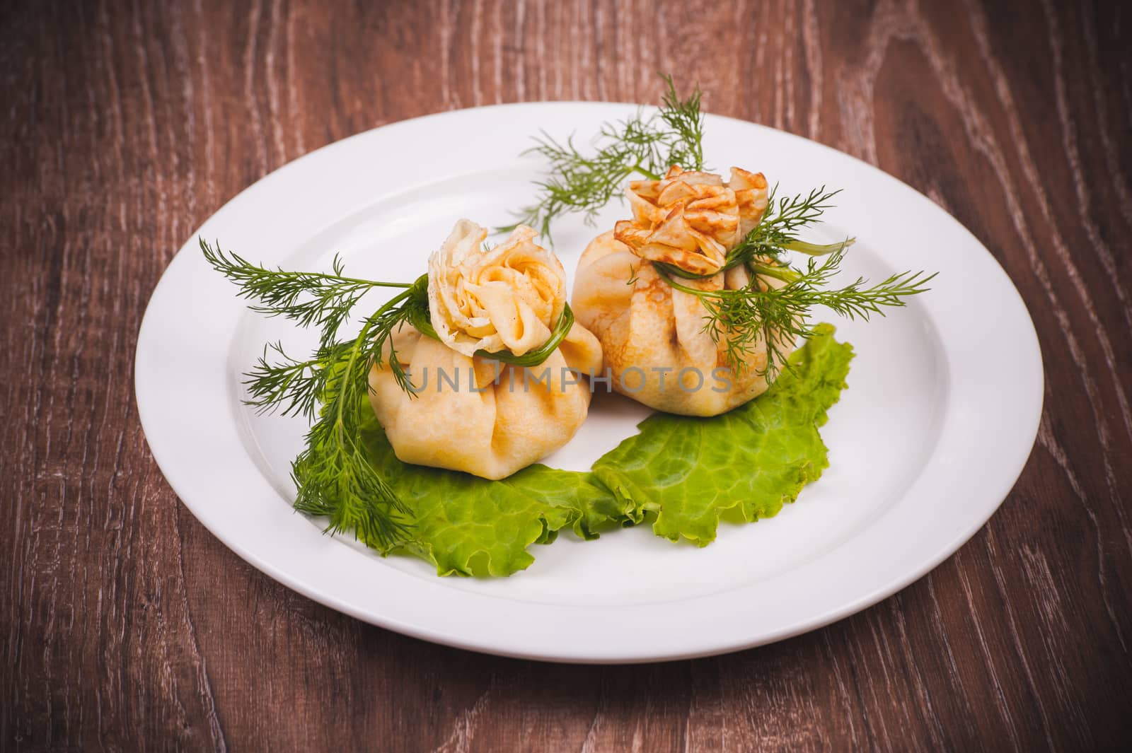 eastern european stuffed pancakes served on white plate