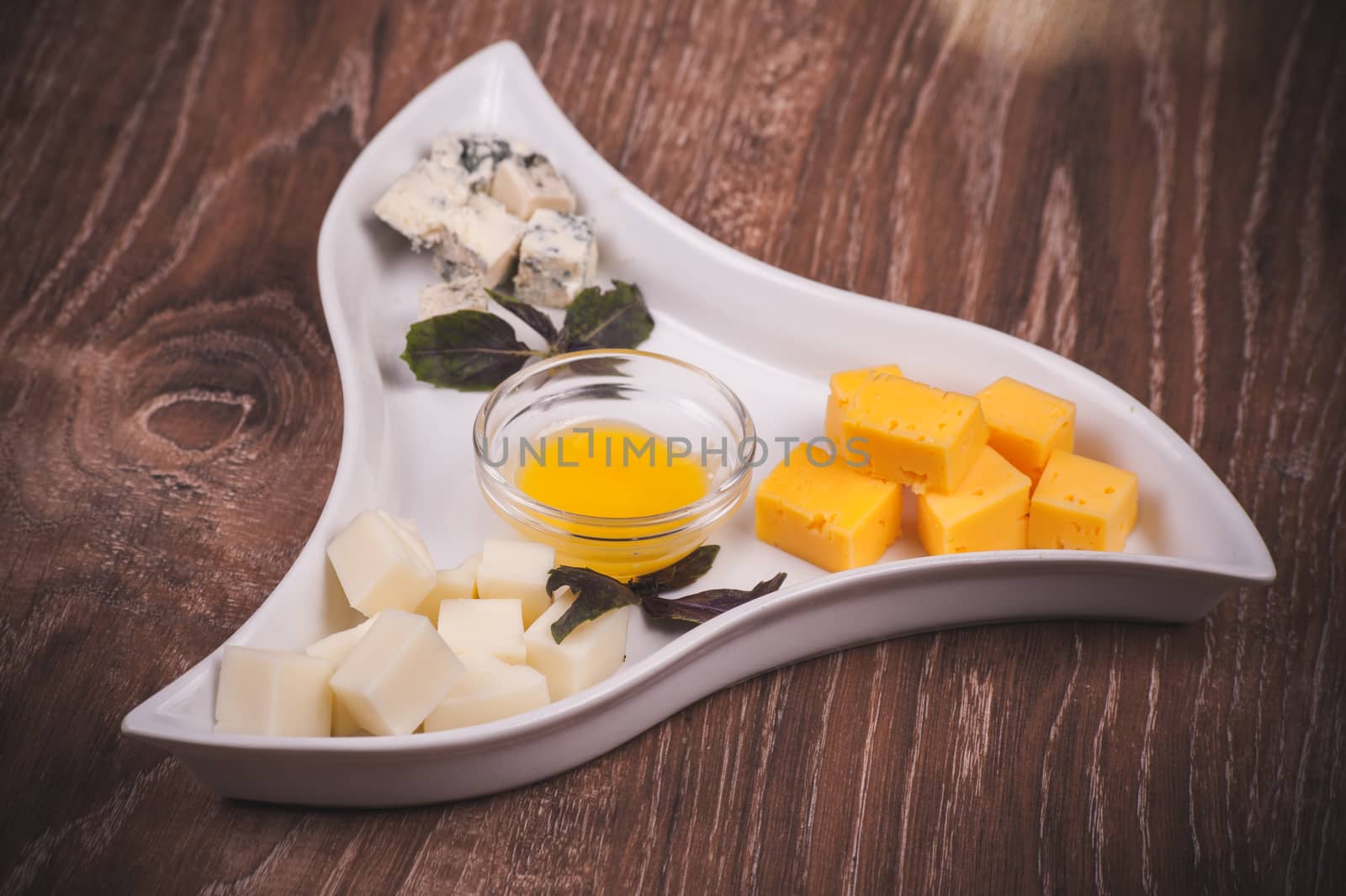 cheese platter with jam on white plate 