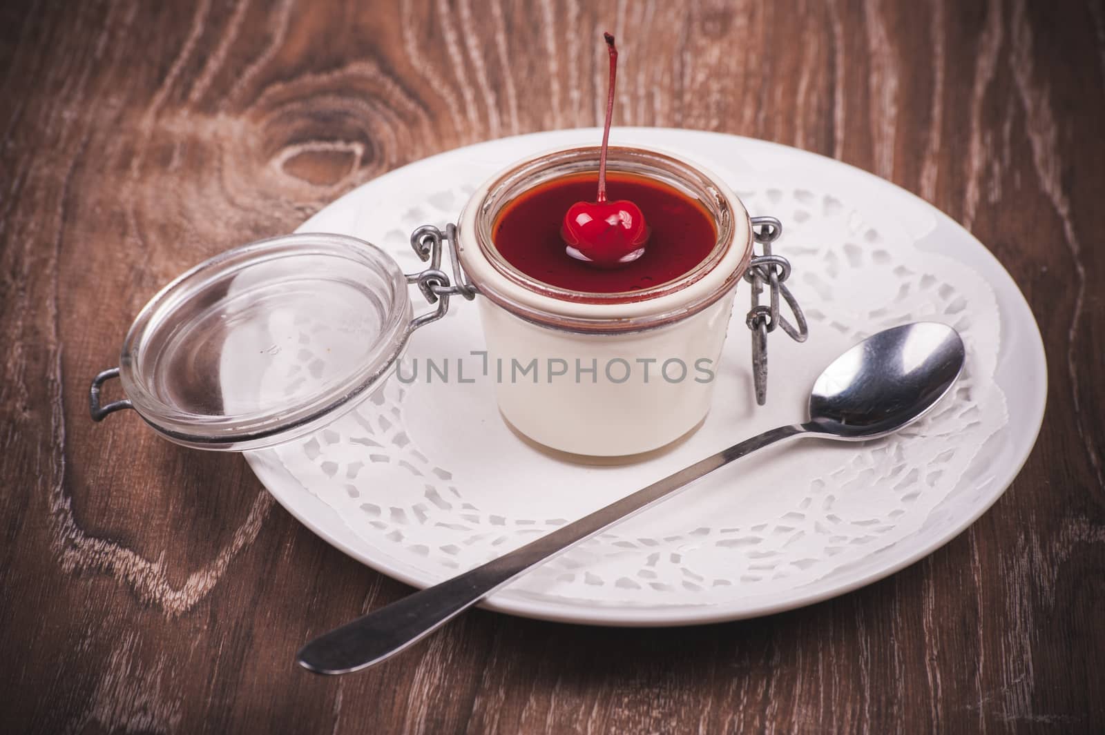 cherry panna cotta in jar with spoon