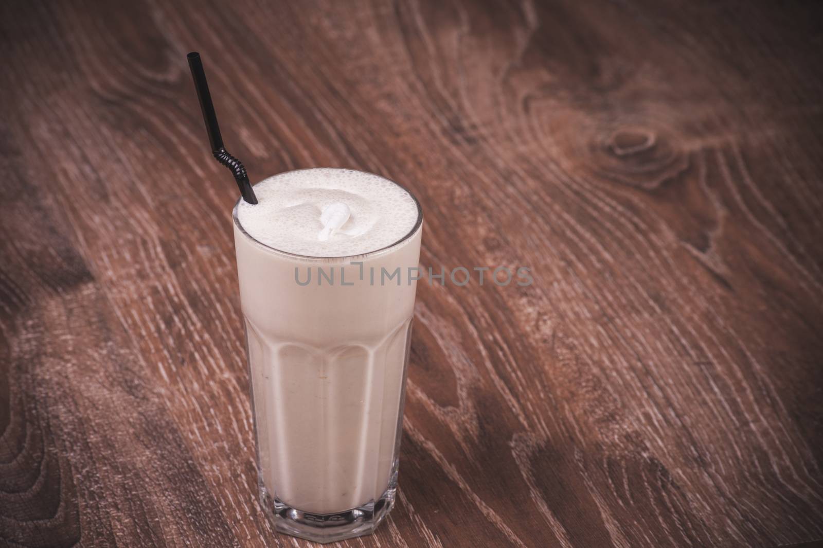 chocolate milk shake in glass with straw