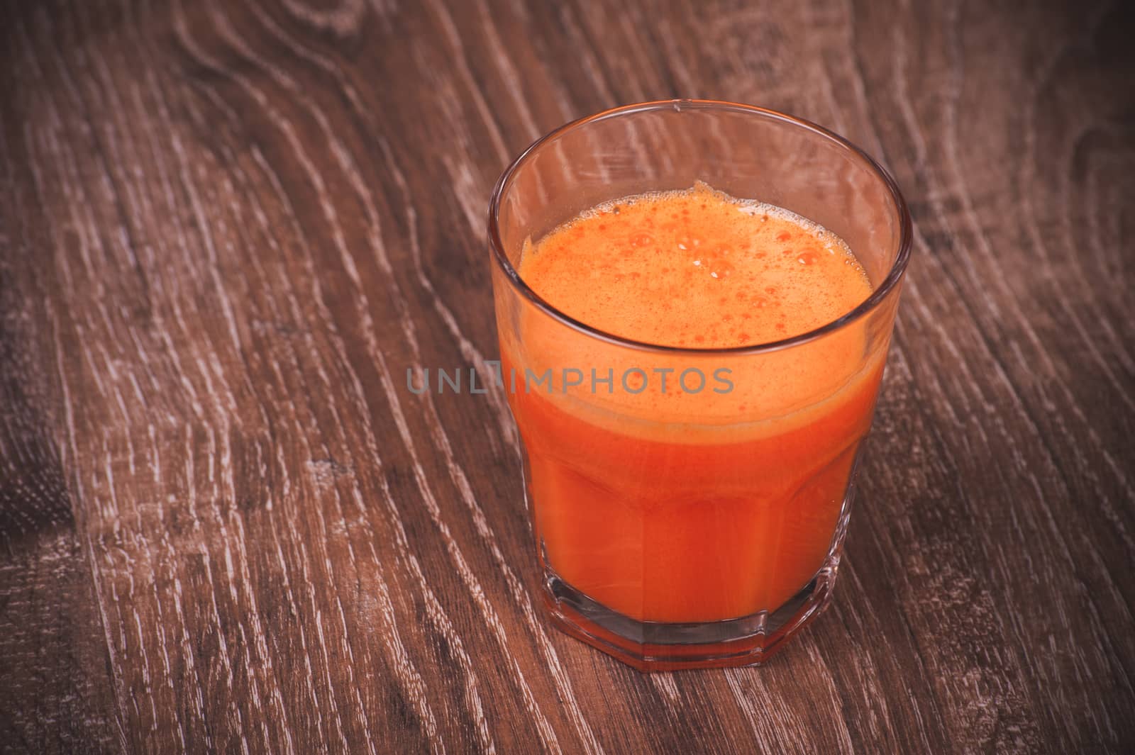 freshly squeezed orange carrot juice in glass 