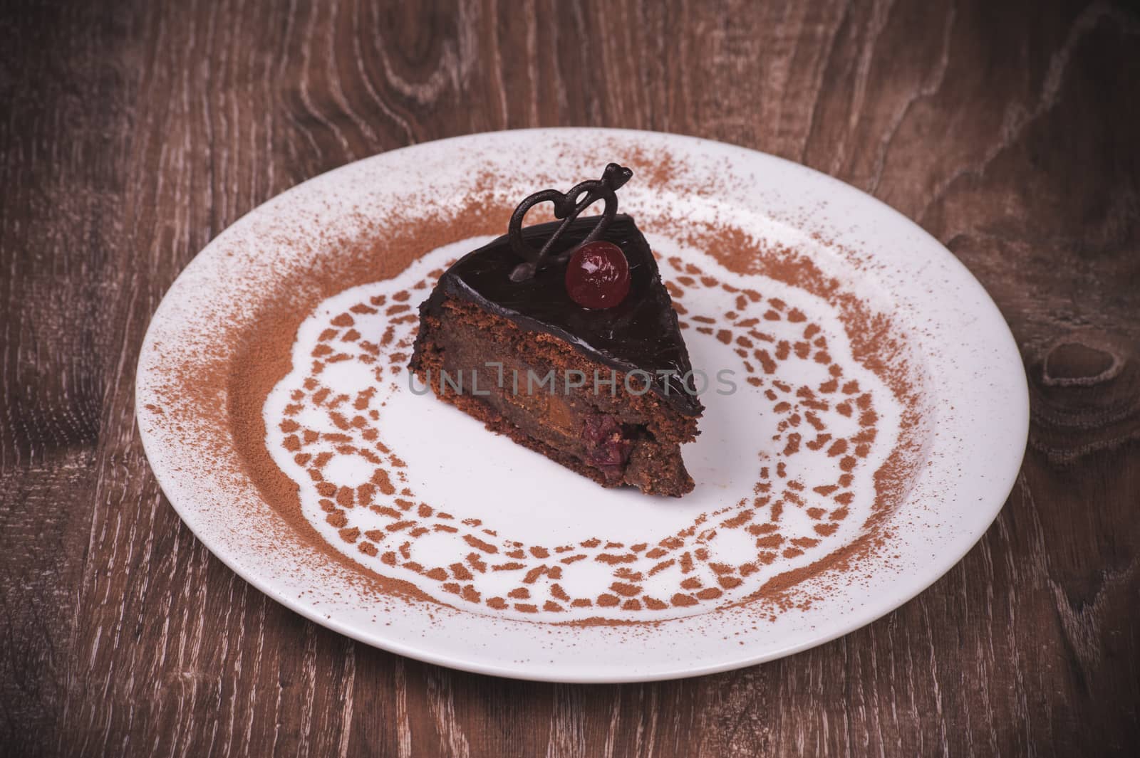 Chocolate and cherry cake slice on white pllate 