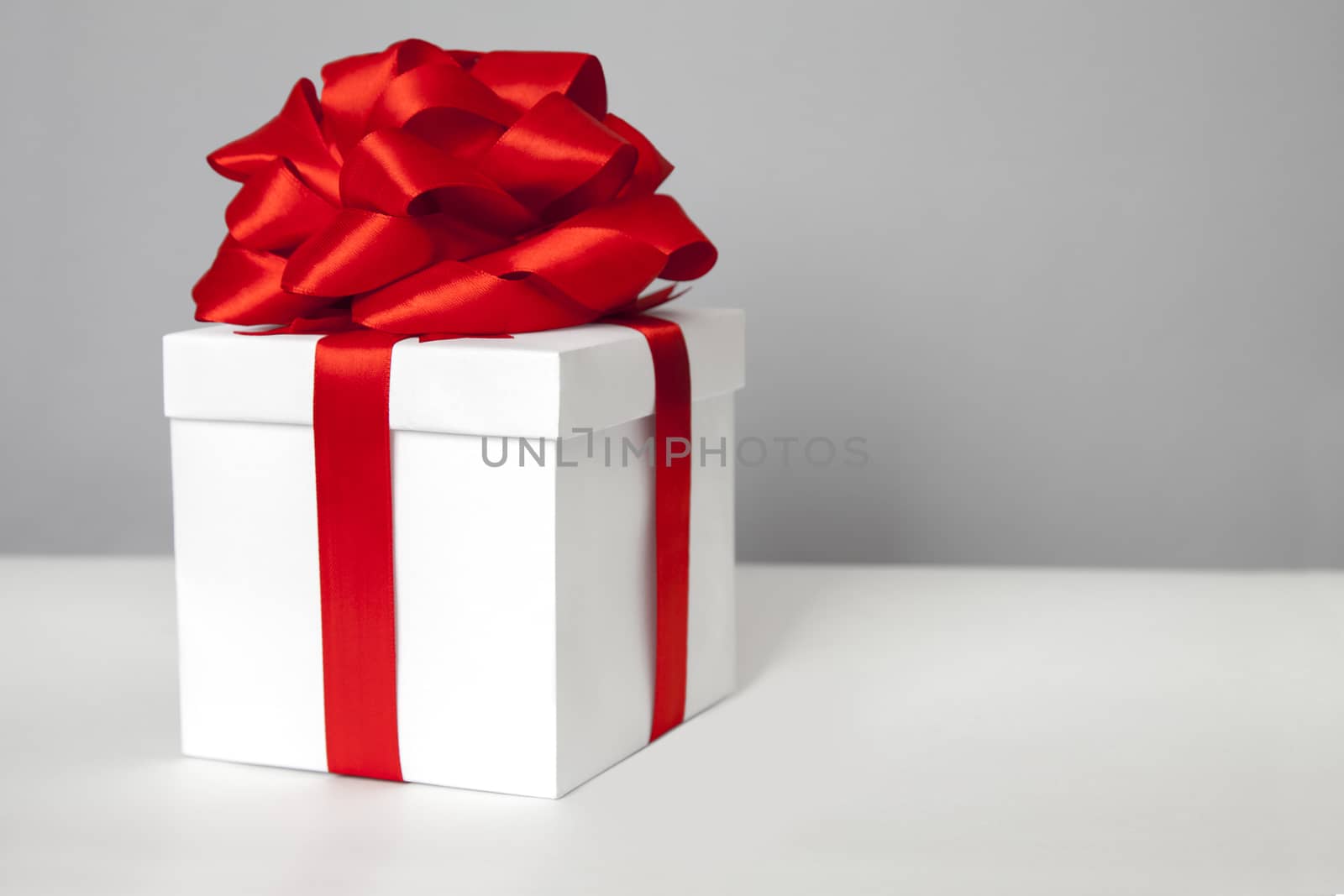 gift box with red ribbon bow by anelina