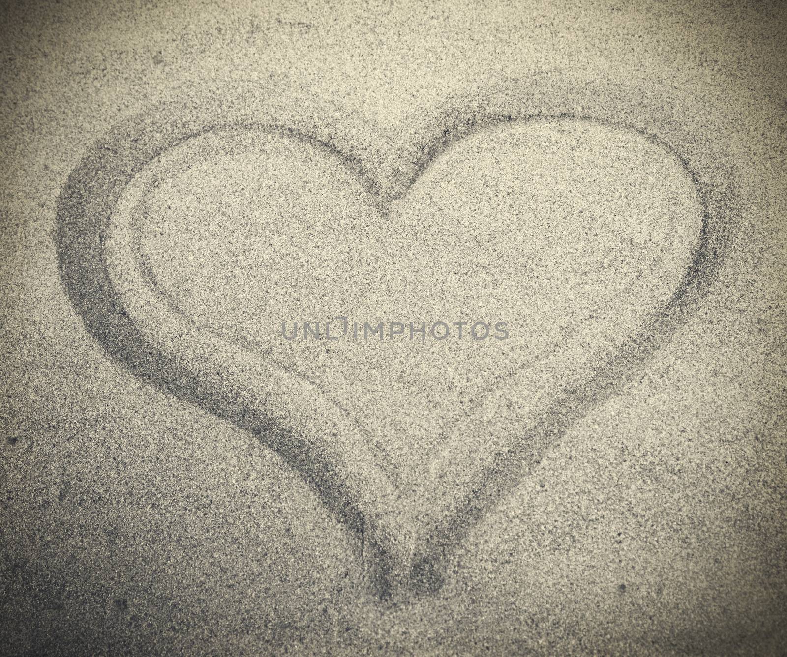 Picture of heart drew on white sand by anelina