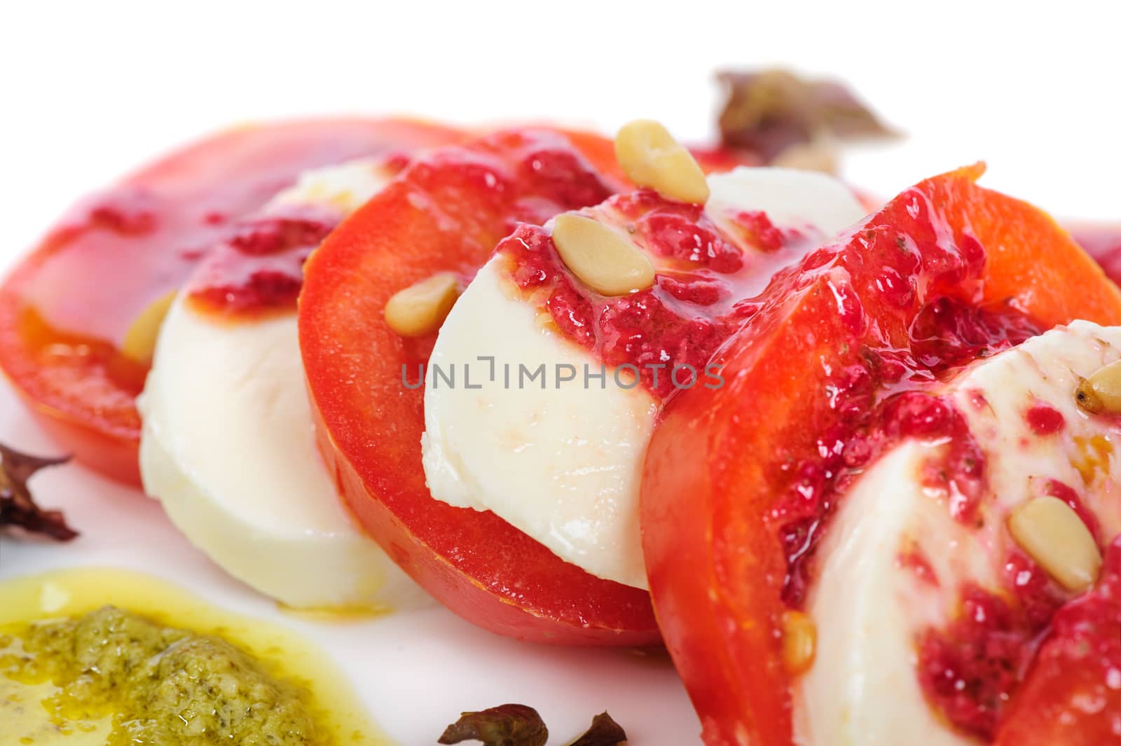 Caprese antipasto salad with mozarella cheese, tomatoes, isolated on white