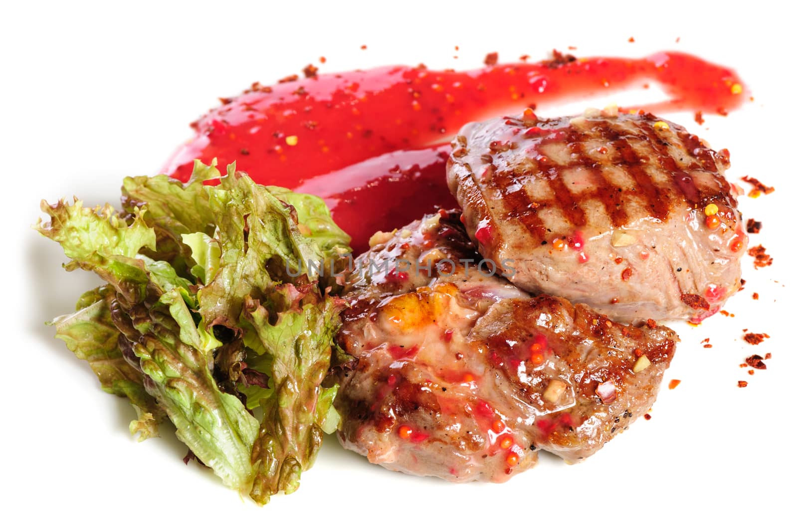 Grilled pork steaks with raspberry sauce and leaf of lettuce