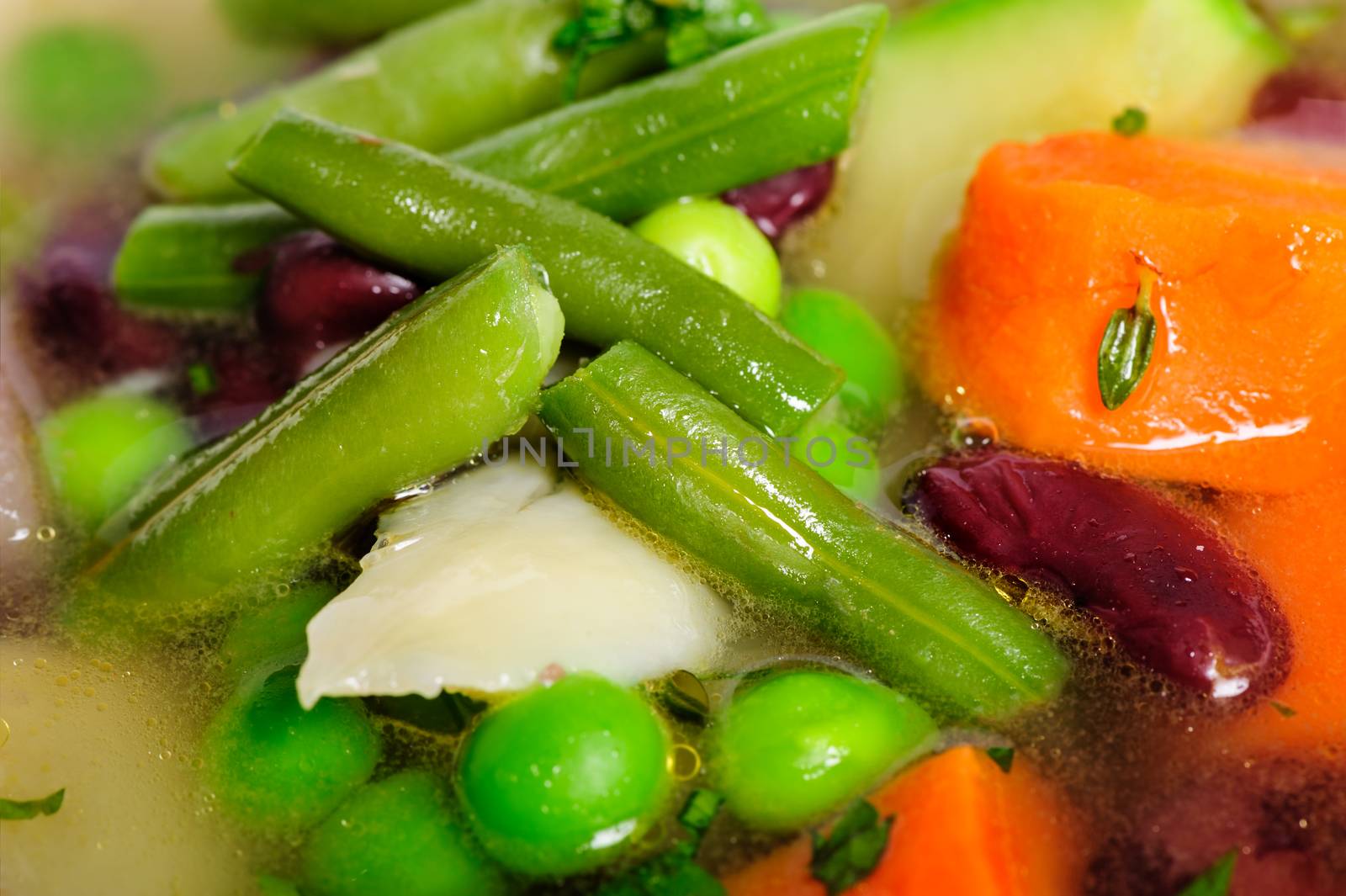 Fresh vegetable soup made of green bean, carrot, potato, red bell pepper, tomato in bowl
