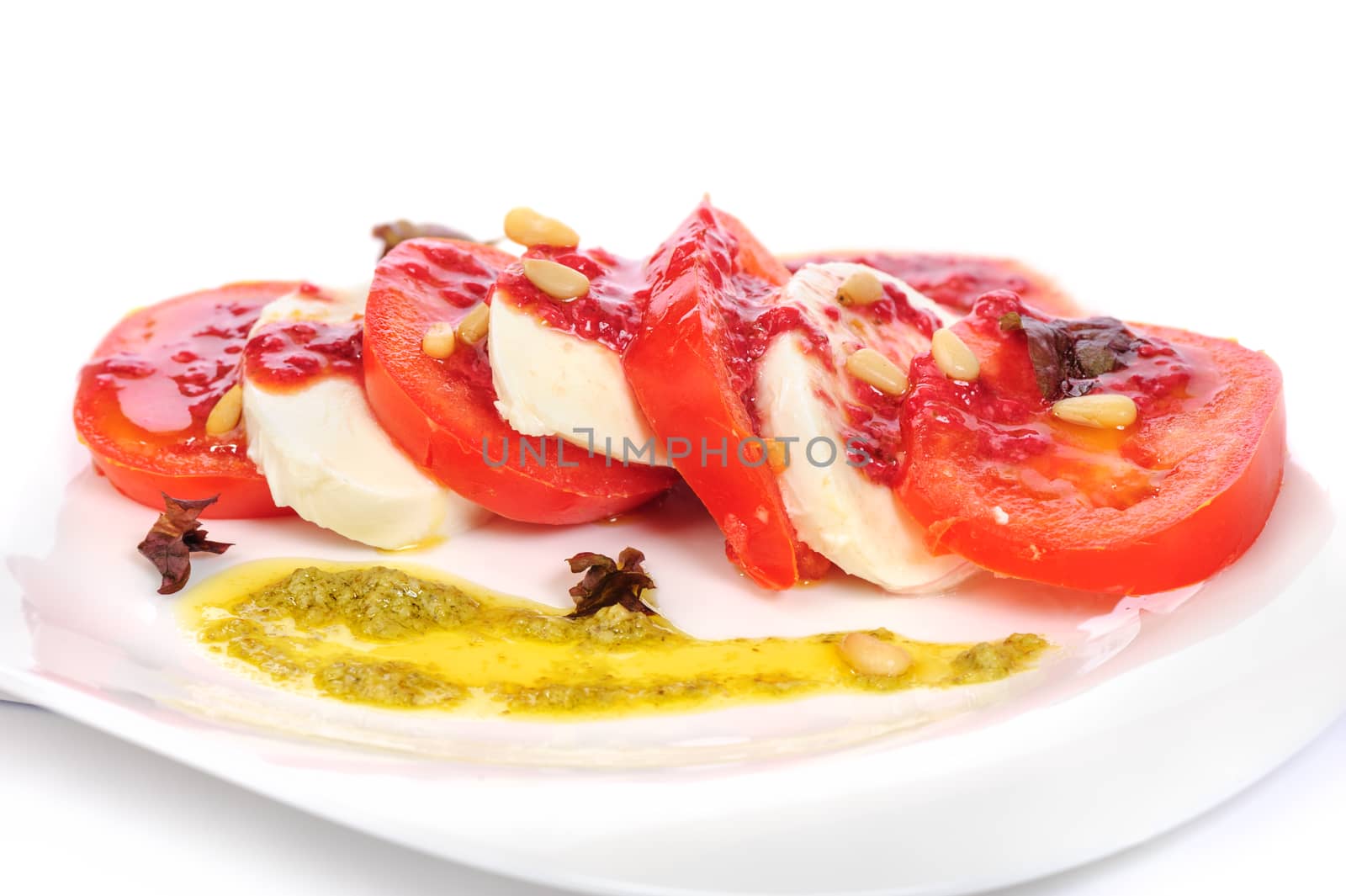 Caprese antipasto salad with mozarella cheese, tomatoes, isolated on white