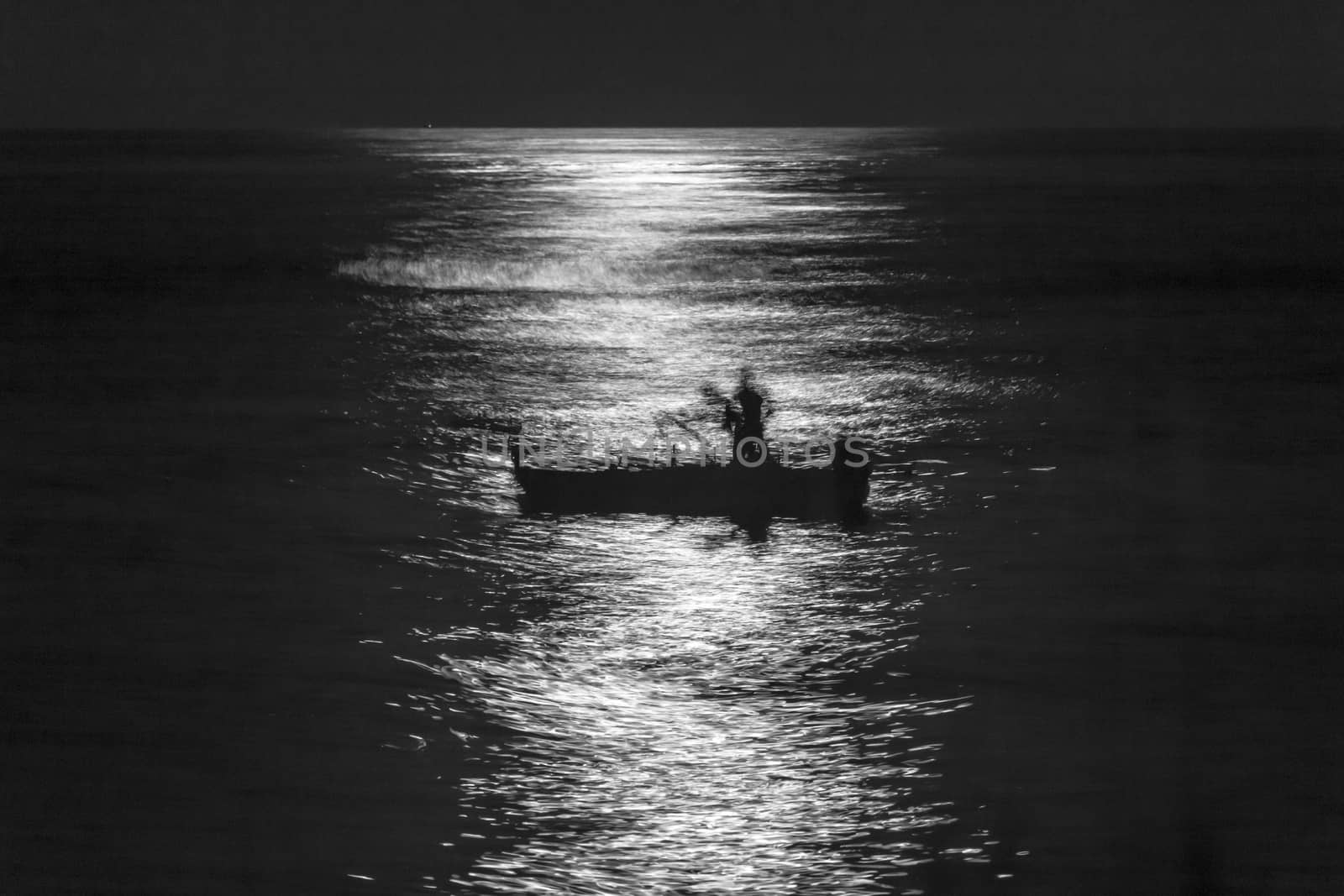Fishermen Silouette at Full Moon in Torre Archirafi little village in east Sicily