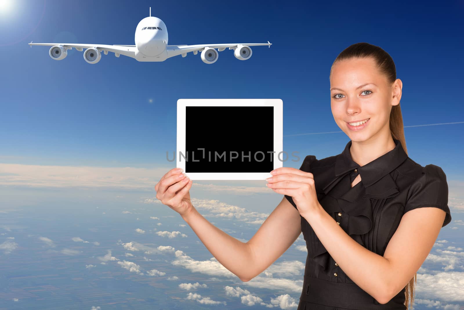 Beautiful businesswoman holding tablet PC. Blue sky, clowds and jet airliner as backdrop by cherezoff