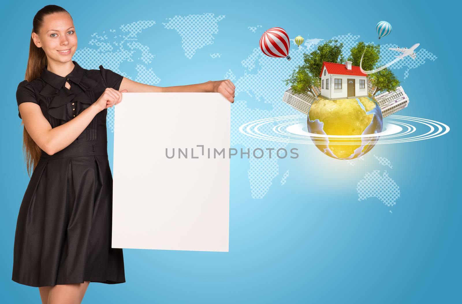 Beautiful businesswoman holding blank paper sheet. Beside is miniature Earth with trees, small house, high-rise buildings, air balloons, airplane, and surrounded by rings.  Contoured world map as backdrop