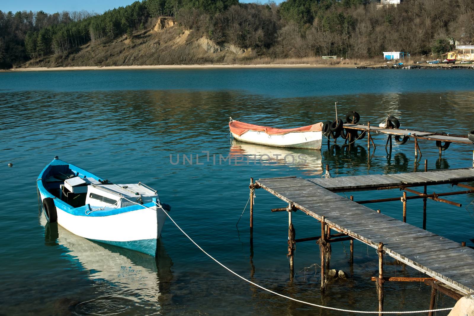 fishing boats to stand beside wooden quay