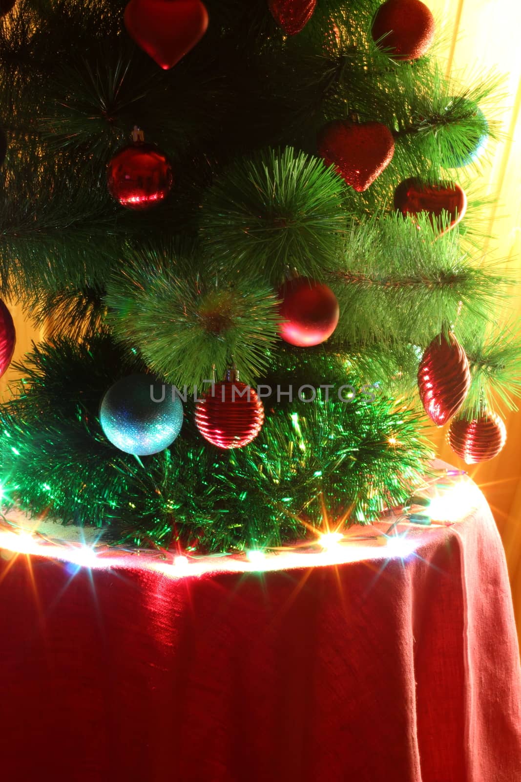 Christmas tree decorated with red and blue toy with a star on top