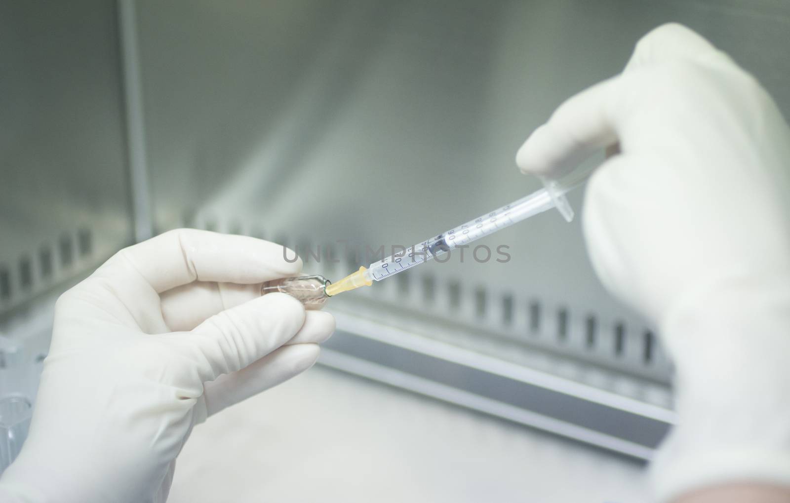 Laboratory technician prepares human growth factors by edwardolive