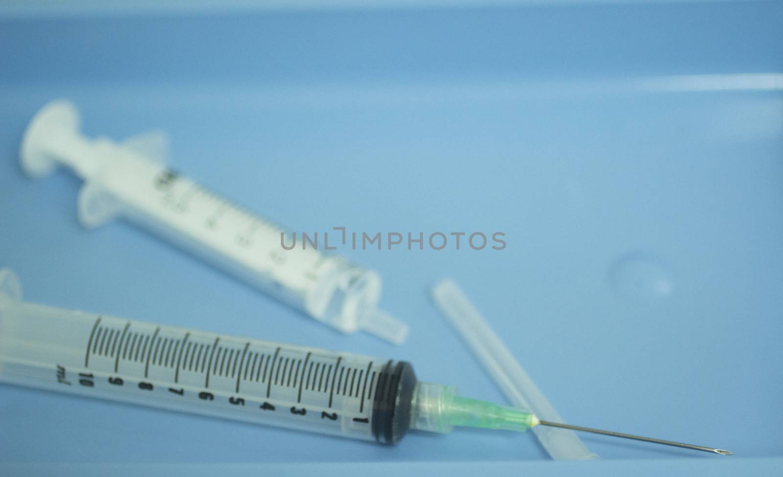 Medical laboratory syringe, sterile swab and tray used for preparation of human growth factors from blood and plasma that has been centrifuged in hospital clinic for orthopedic surgery and Traumatology rehabilitation treatment in sterile environment.