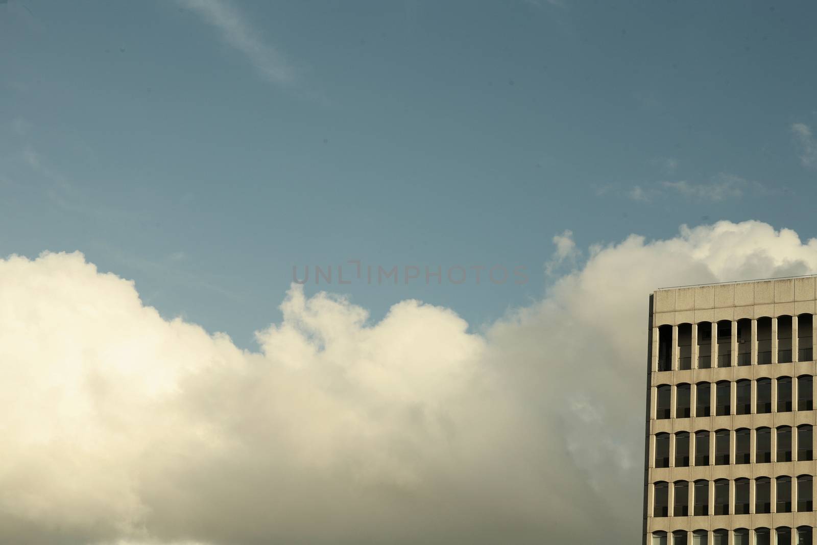 Sky on cold winter day clouds and city office block by edwardolive