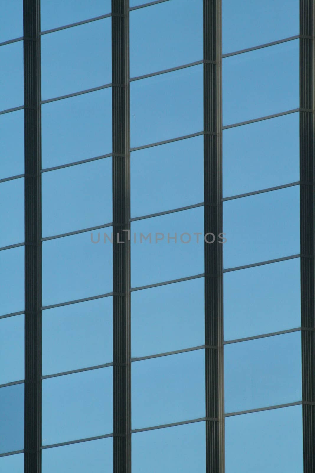 Skyscraper office tower block windows in lines semi abstract shot in business district downtown Madrid Spain. 