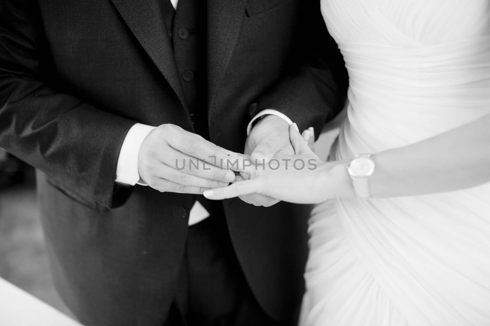 Hands of bride and bridegroom in wedding marriage ceremony by edwardolive
