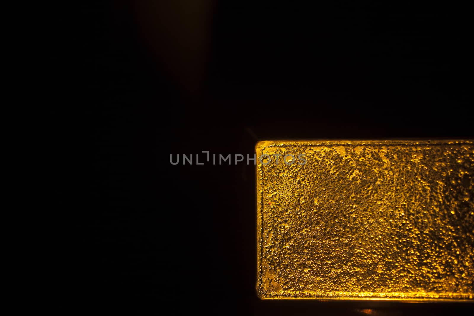 1 kg Gold bullion bar 999.9 on plain black studio background with publicity copy space. 