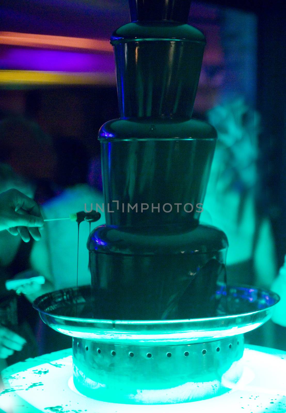 Dipping fruit in a chocolate fountain wedding party by edwardolive
