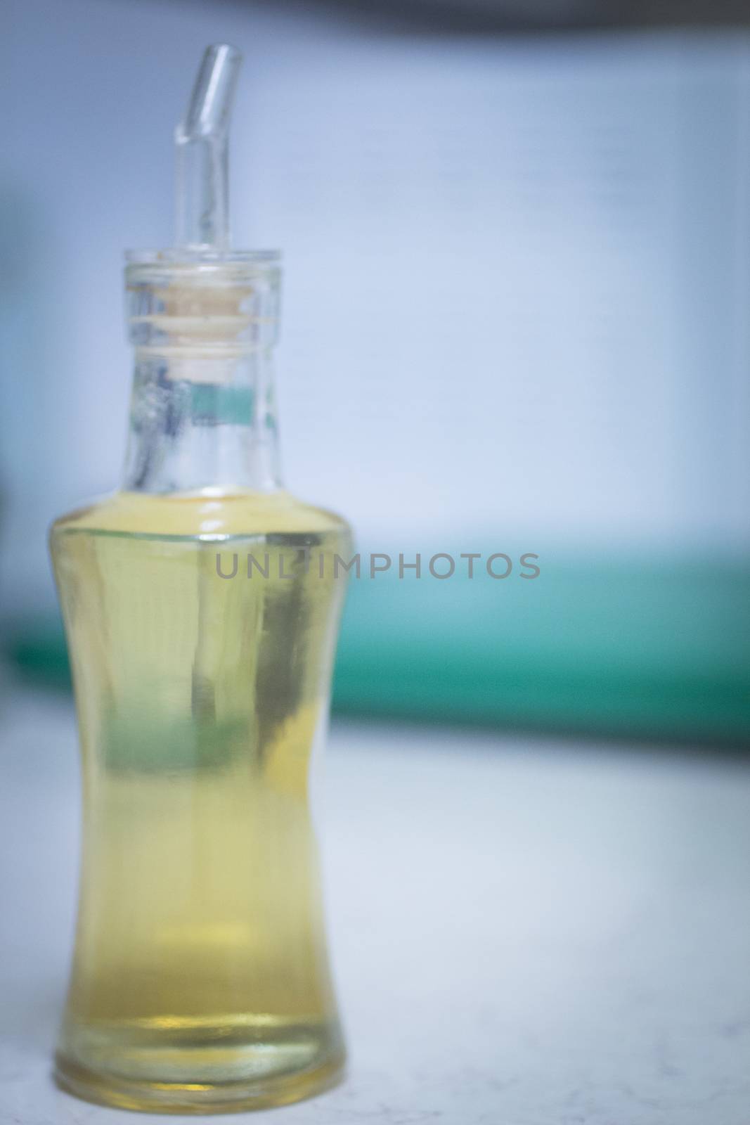Bottle of white wine vinegar in kitchen on bench by edwardolive