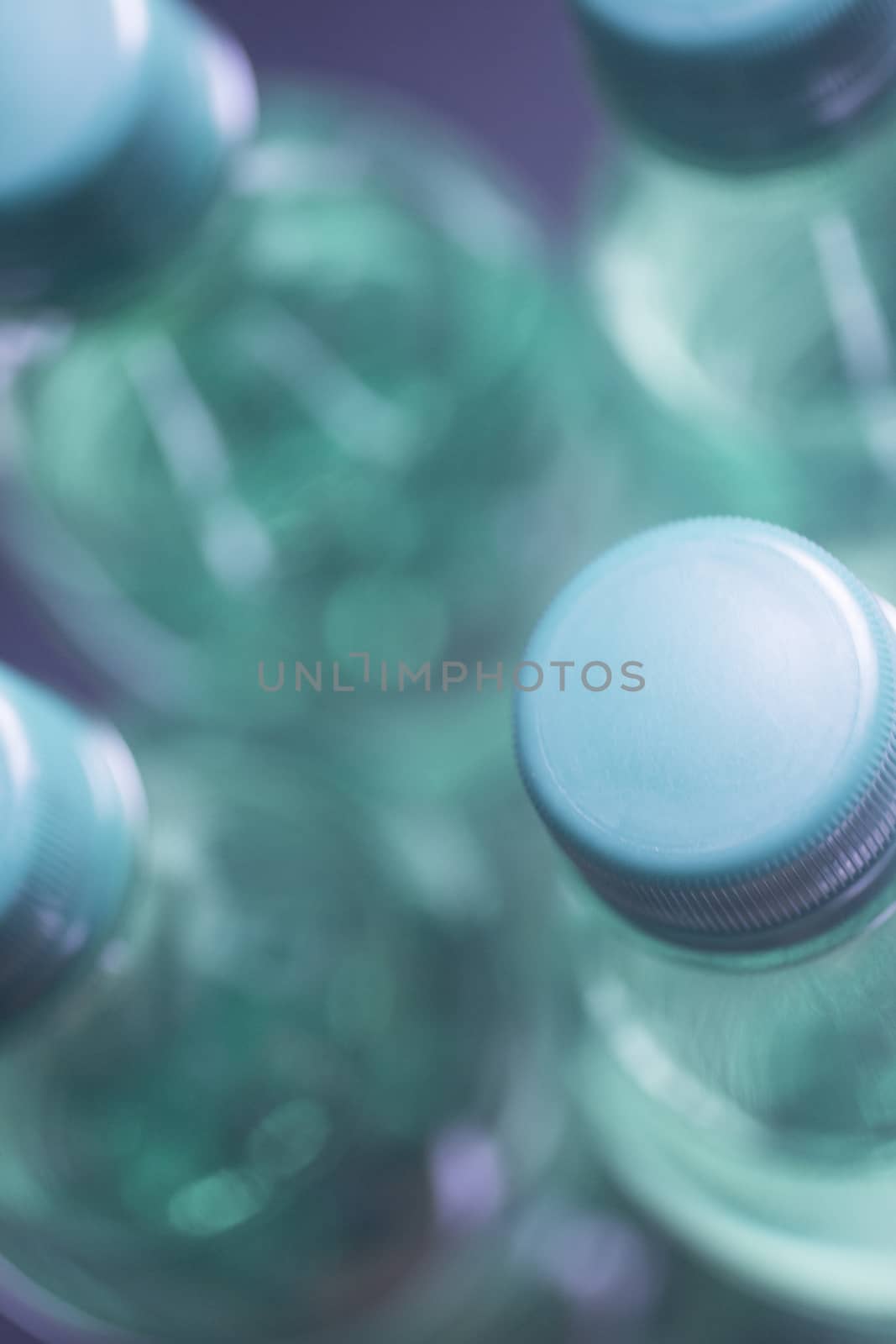 Isolated plastic water bottles blue background studio by edwardolive