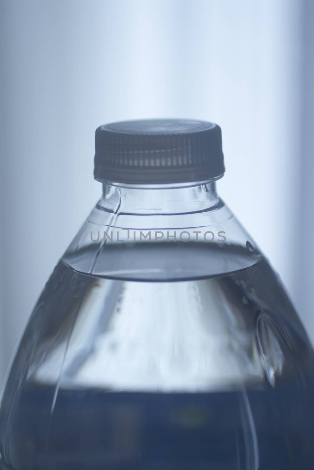 Isolated plastic water bottle blue background studio by edwardolive