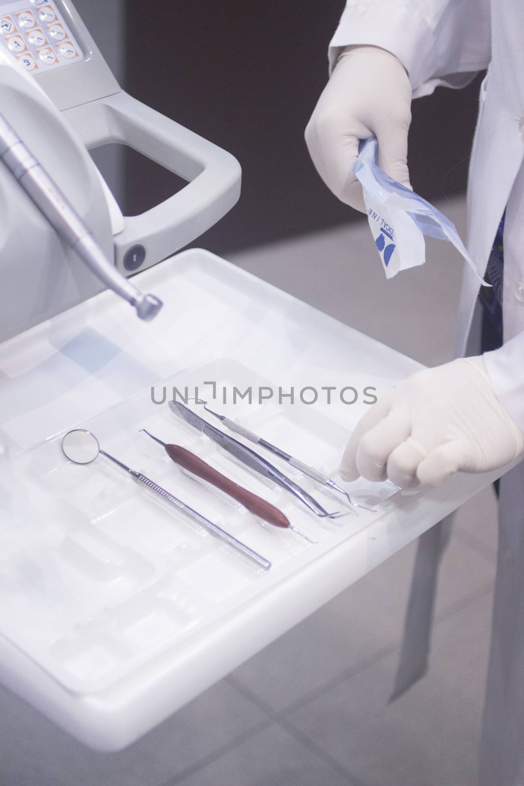 Dental instrumentation dentist drill tooth dental cleaning tool in the hand of dentist in dentists surgery clinic artistic color photo with low depth of focus.