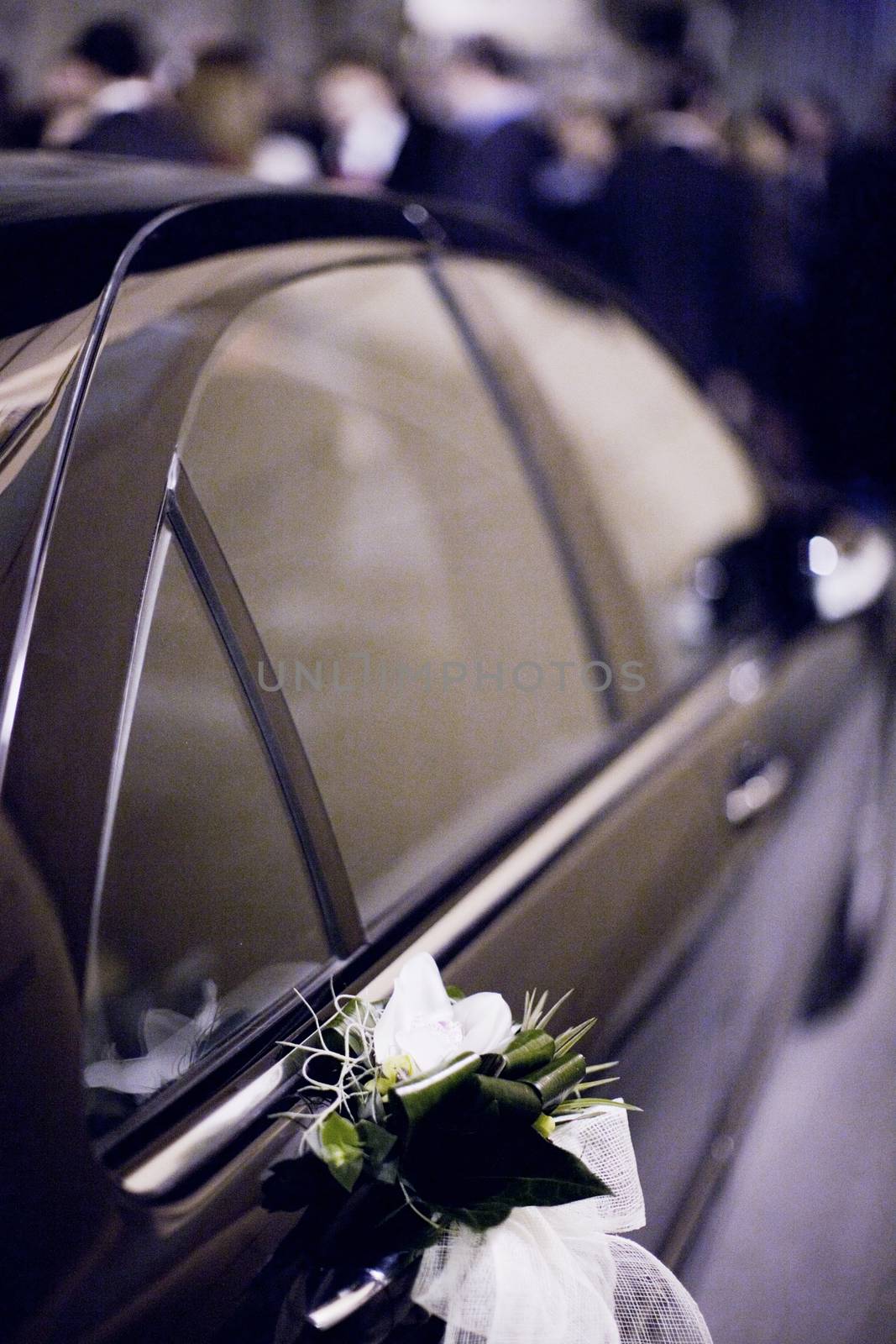 Bridal white flower bouquet on wedding car door by edwardolive