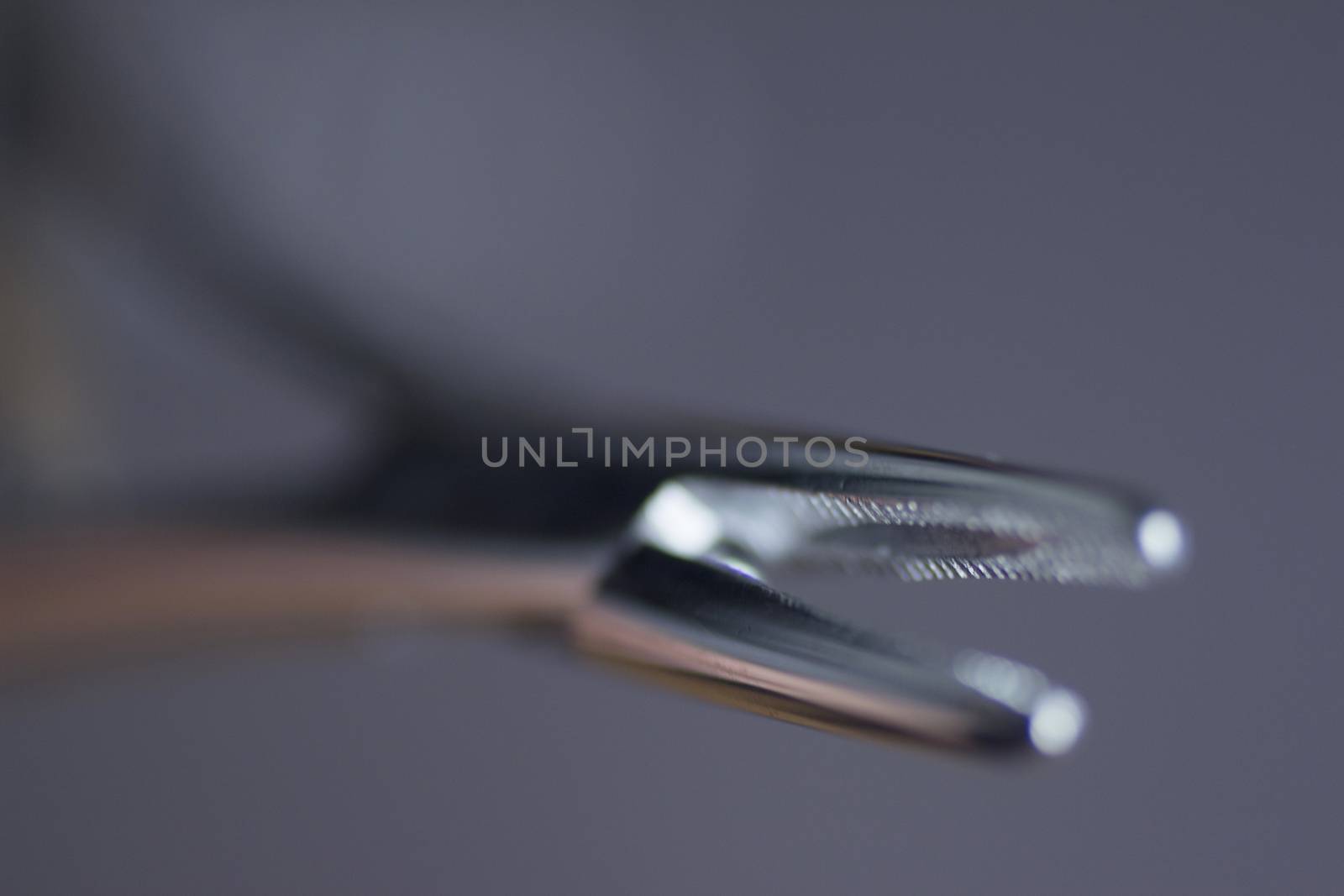 Traumatology and orthopedic surgery metal pliers. Still life color digital photo in purple tones with shallow depth of focus bokeh artistic effect. 