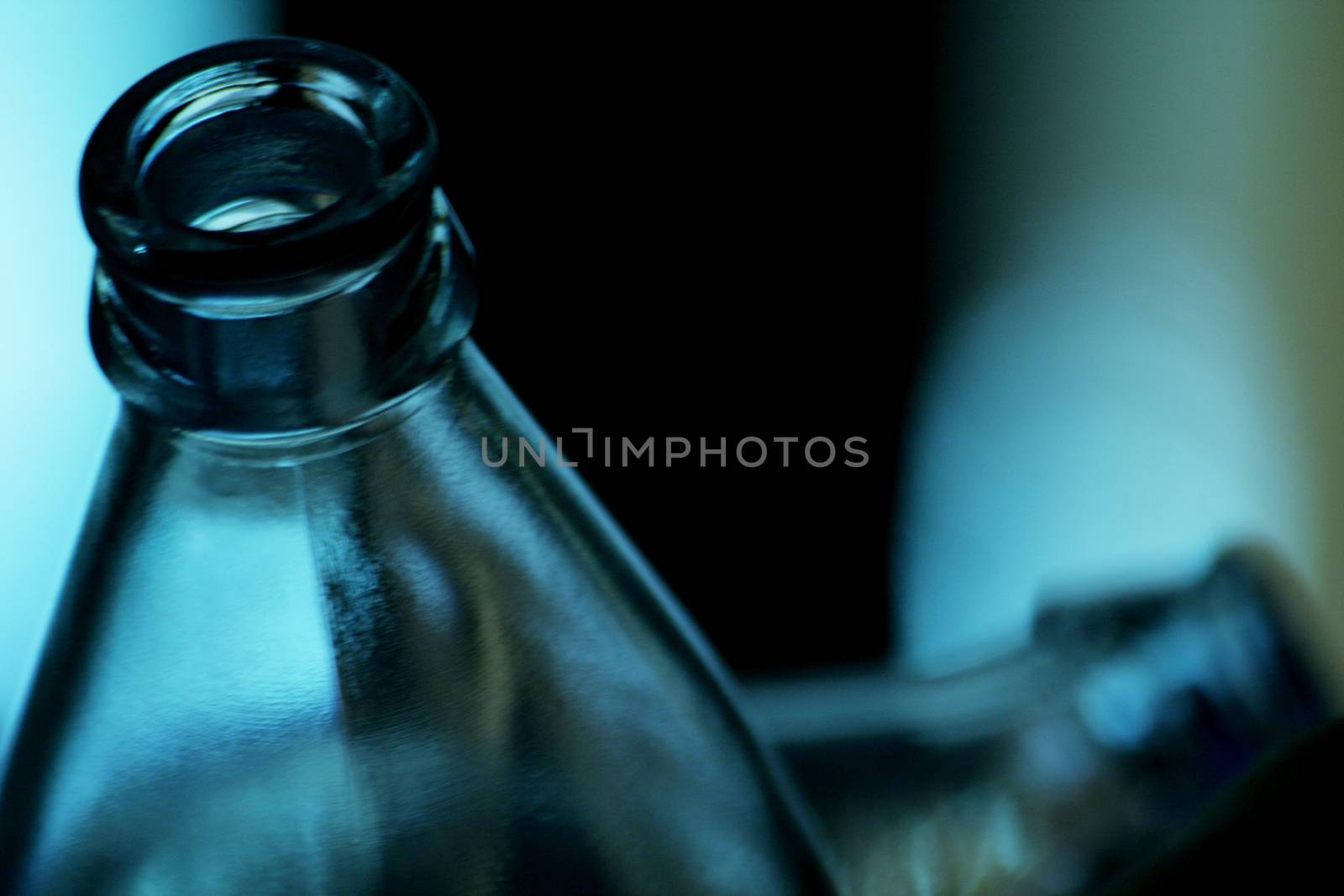 Empty glass water bottles in restaurant bar nightclub by edwardolive
