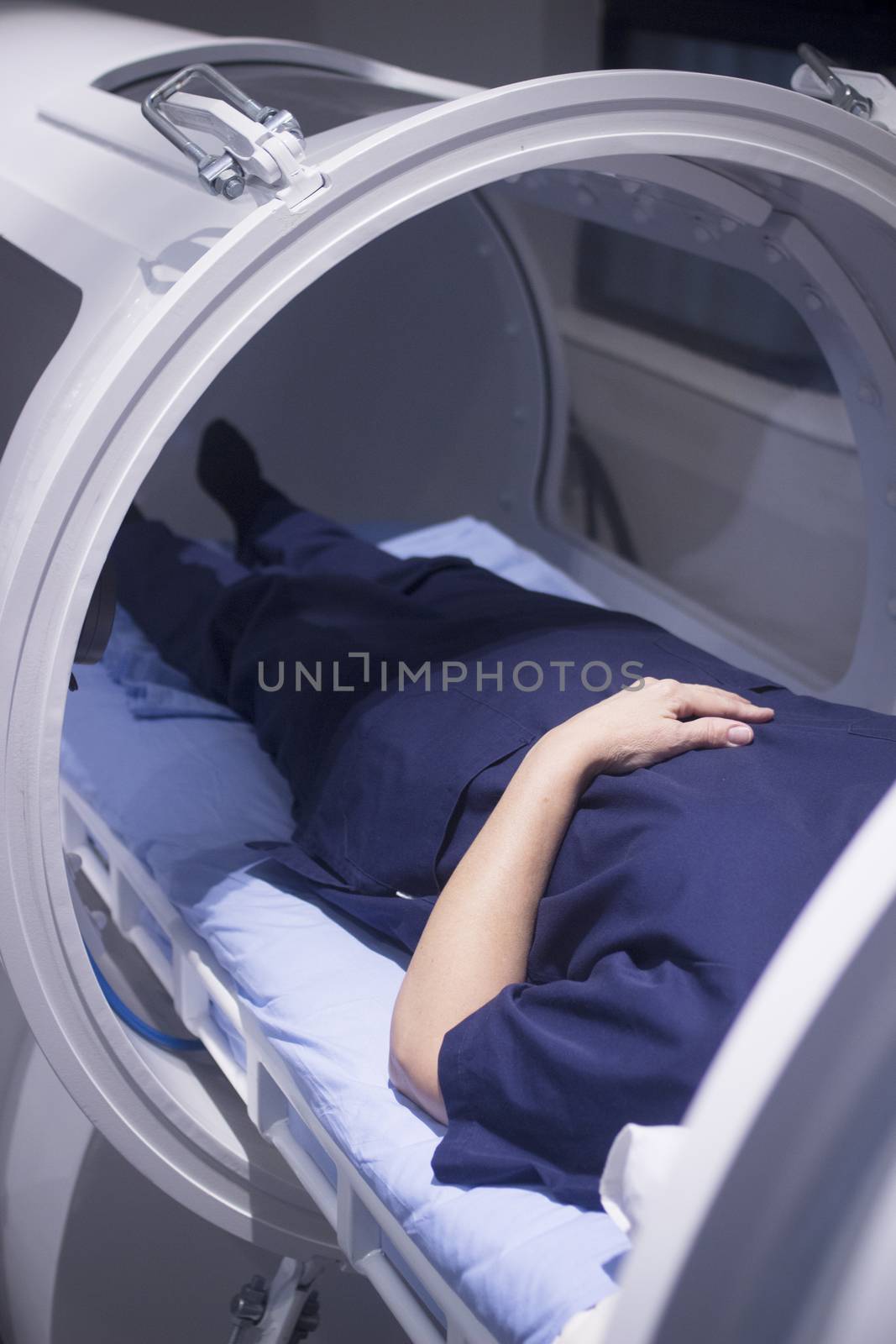 Female patient in oxygen hyperbaric chamber HBOT  by edwardolive