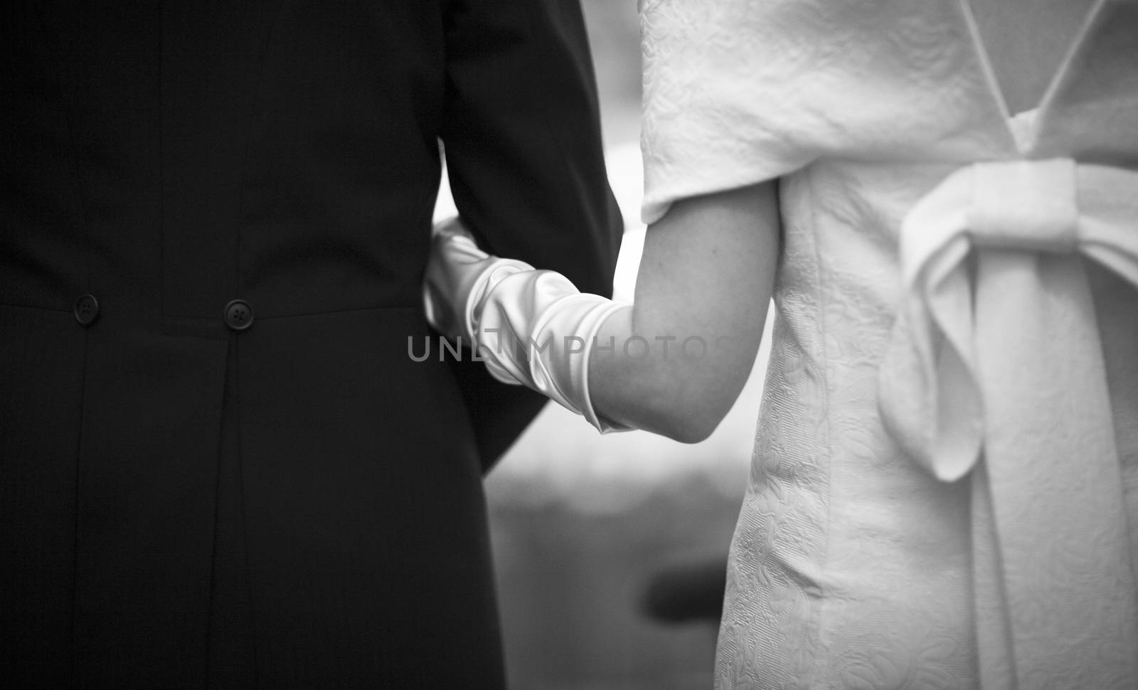 Bride and bridegroom in wedding marriage holding hands by edwardolive