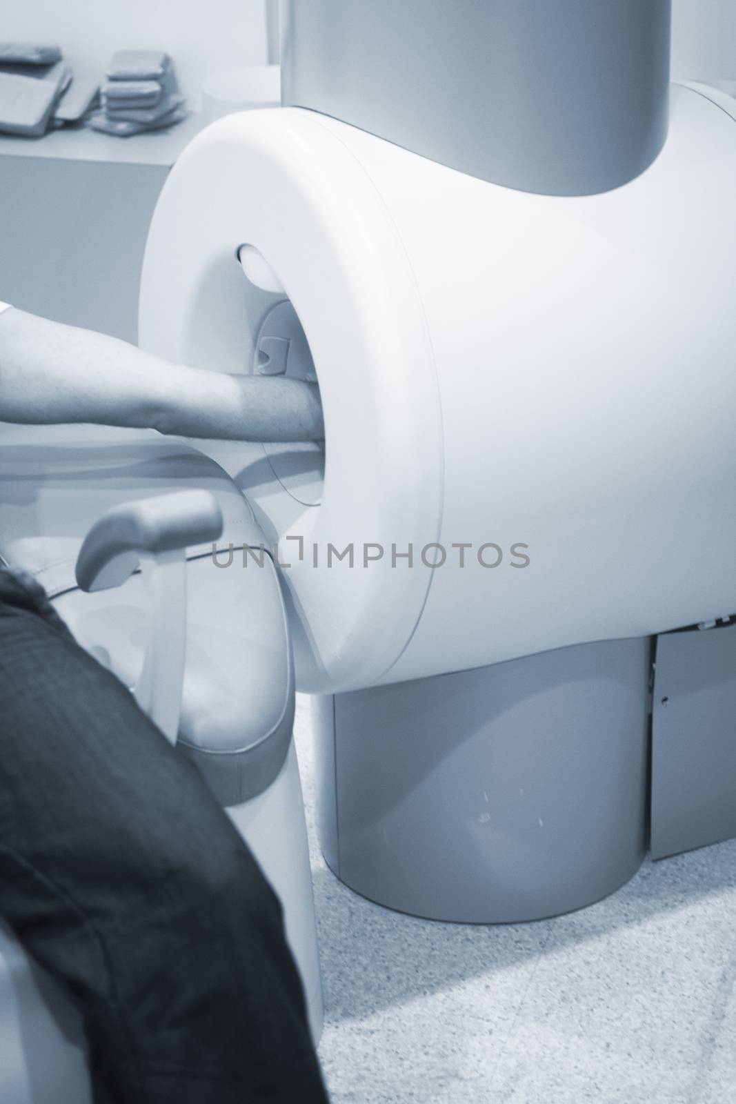 Patient and Doctor in fully open high field Magnetic Resonance Image MRI CAT Scan scanning arm, wrist, hand and elbow. 