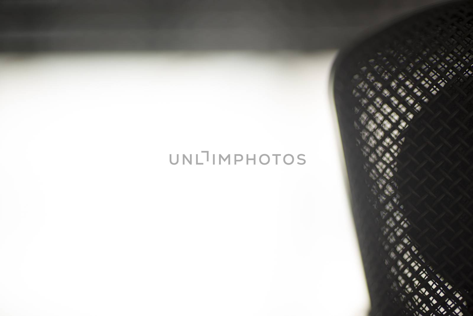 Silhouette of professional large diaphragm studio voice recording microphone. Artistic color digital photo with shallow depth of focus and negative space and white background. 