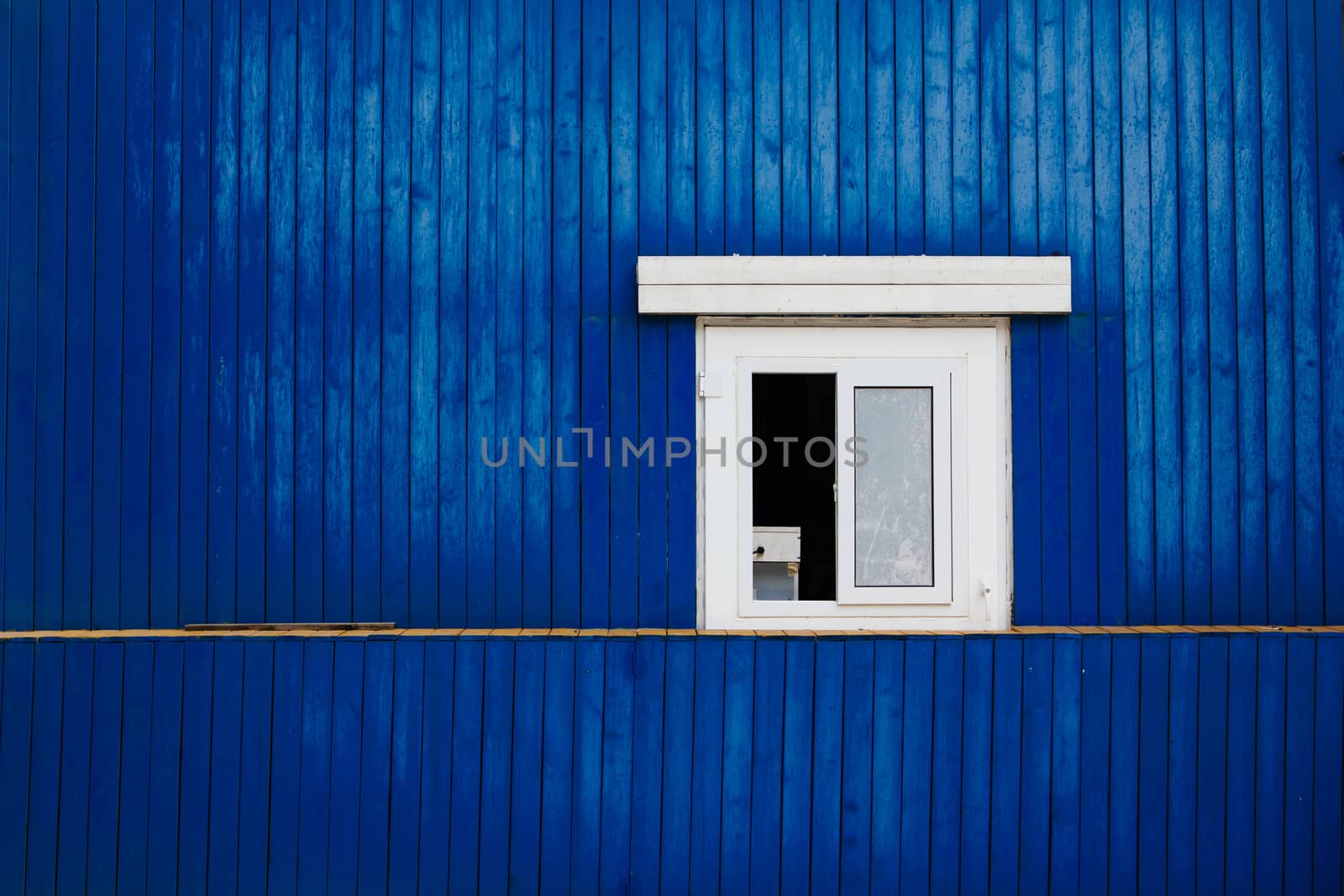 window on the blue wooden wall