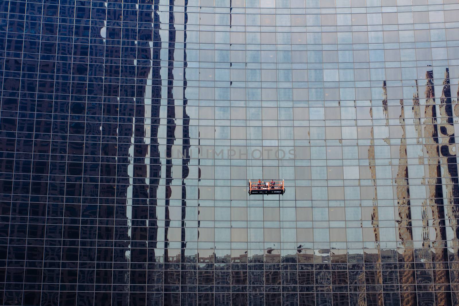 workers are leaning glass wall