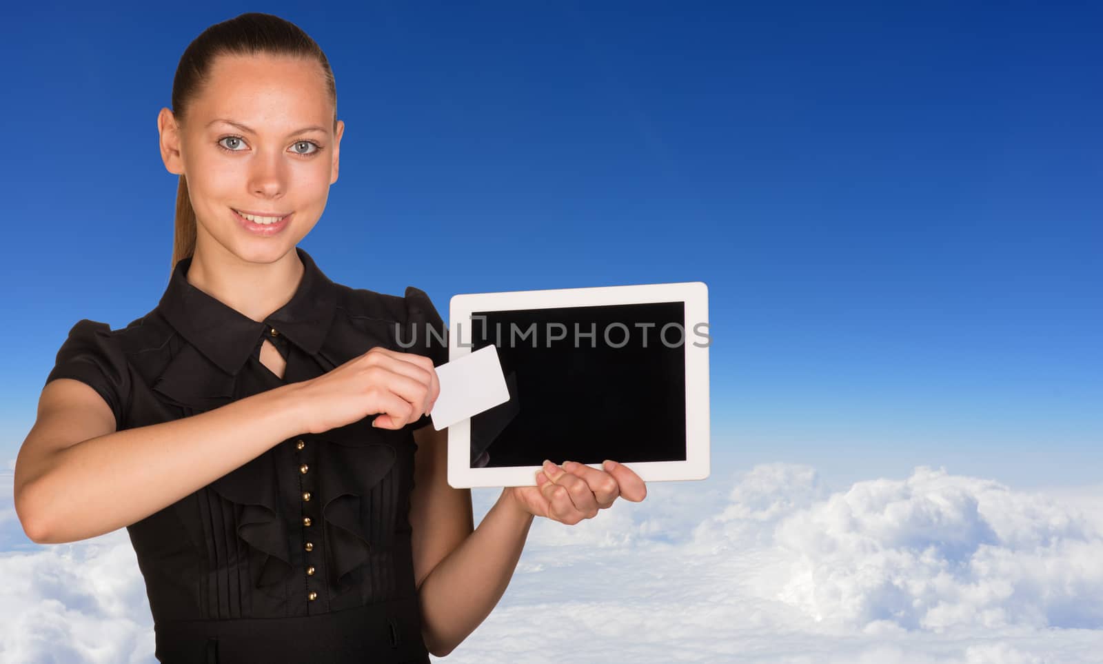 Beautiful businesswoman holding blank tablet PC and blank business card in front of PC screen. Blue sky and cloud layer as backdrop