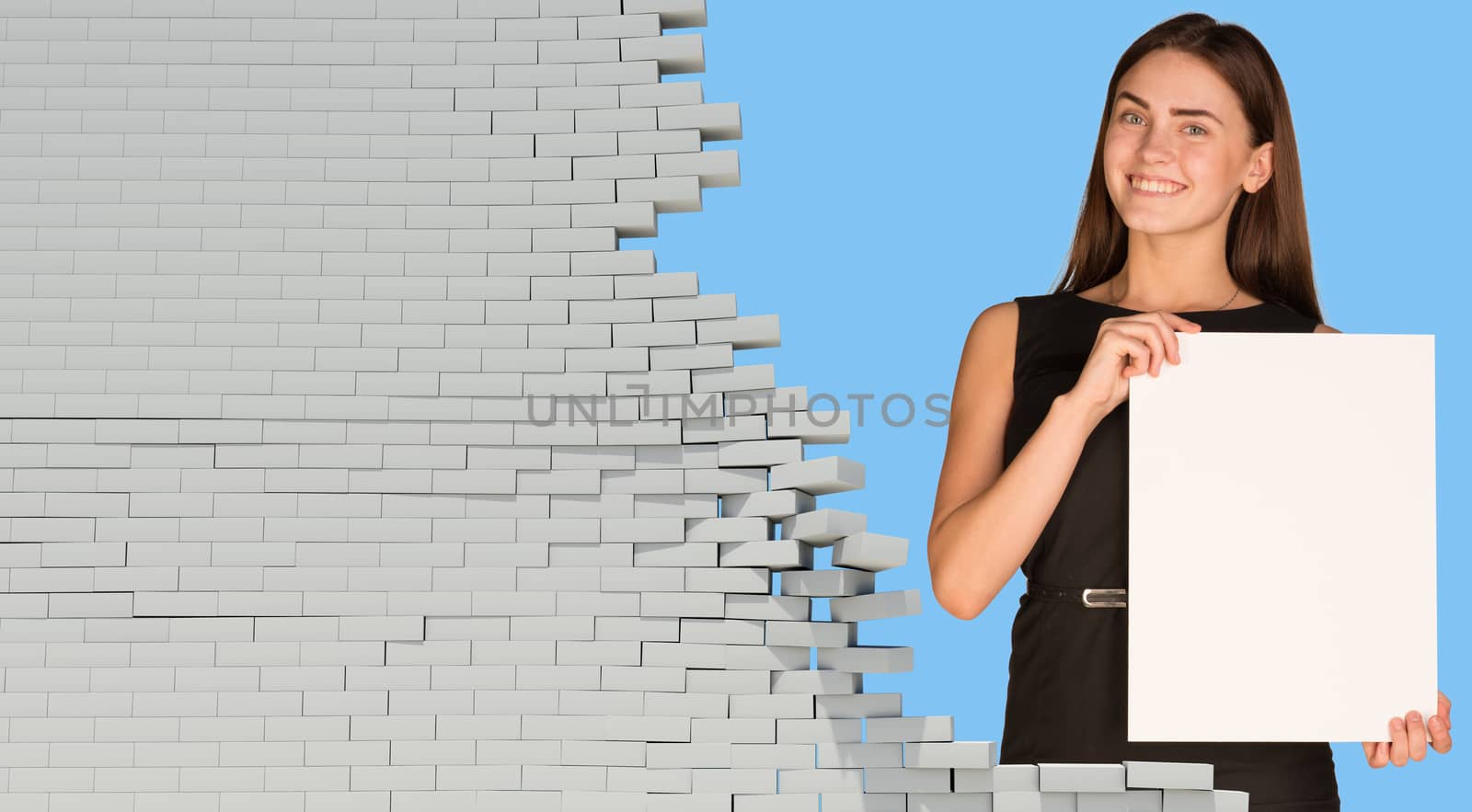 Beautiful businesswoman holding blank paper sheet. Dilapidated brick wall as backdrop. Business concept