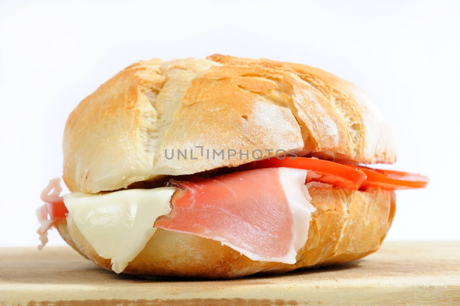 Realization sandwich stuffed with speck ham, cheese and tomato.