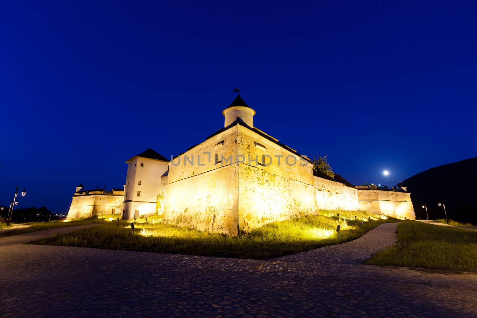 Old fortress "Cetatuia" illuminated at night, Brasov, Romania