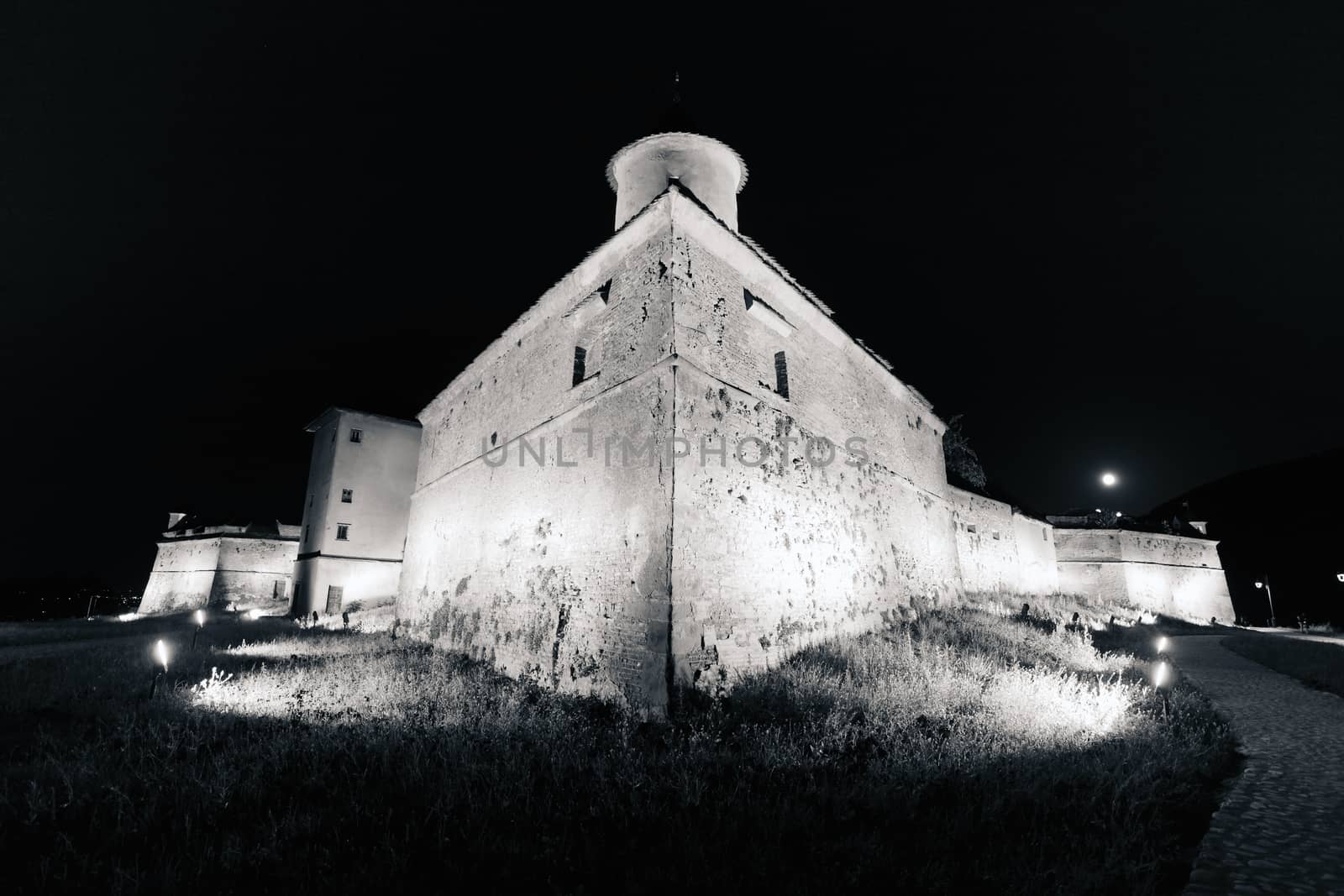 Old fortress "Cetatuia" illuminated at night, Brasov, Romania