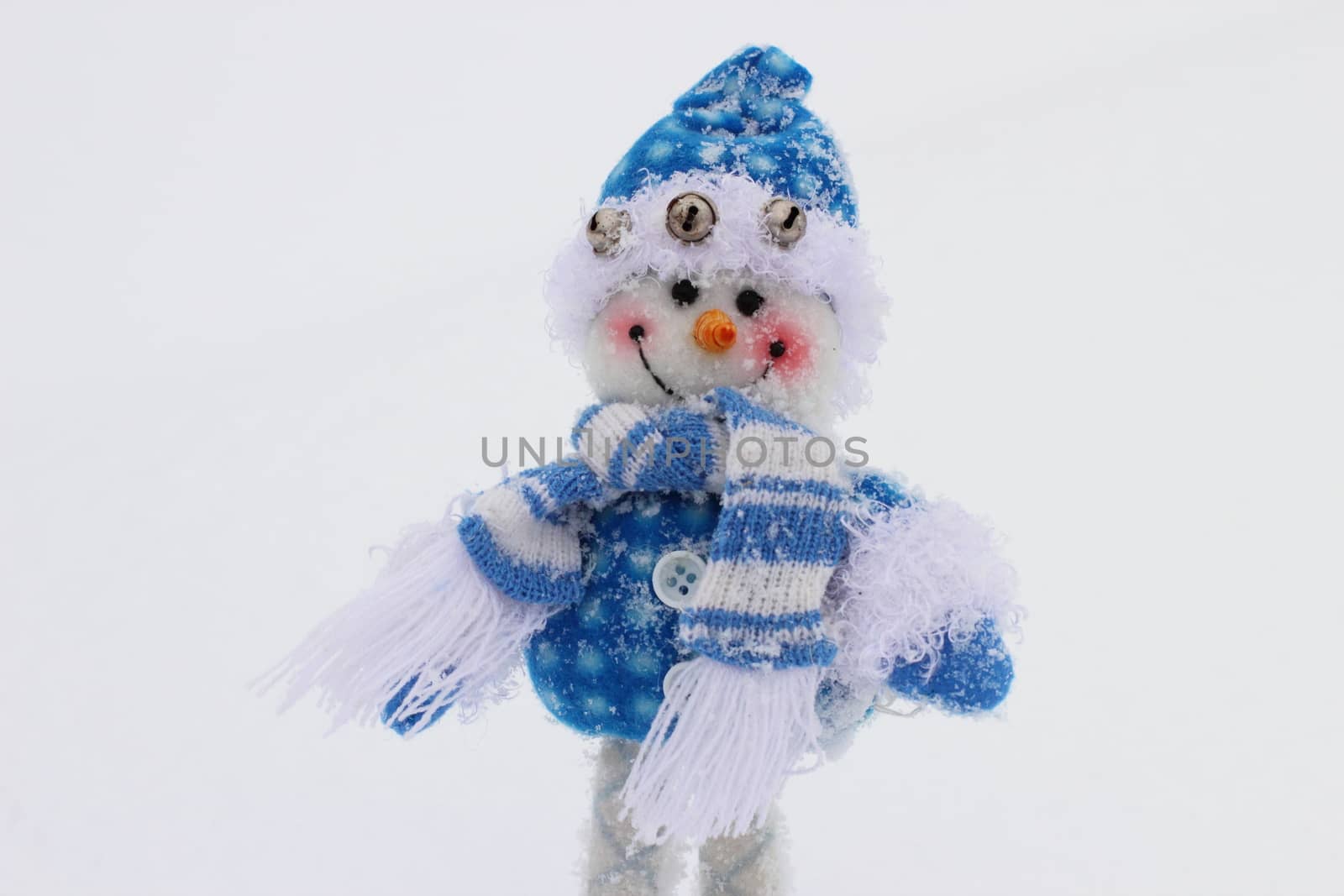 toy snowman in the street in winter clothes
