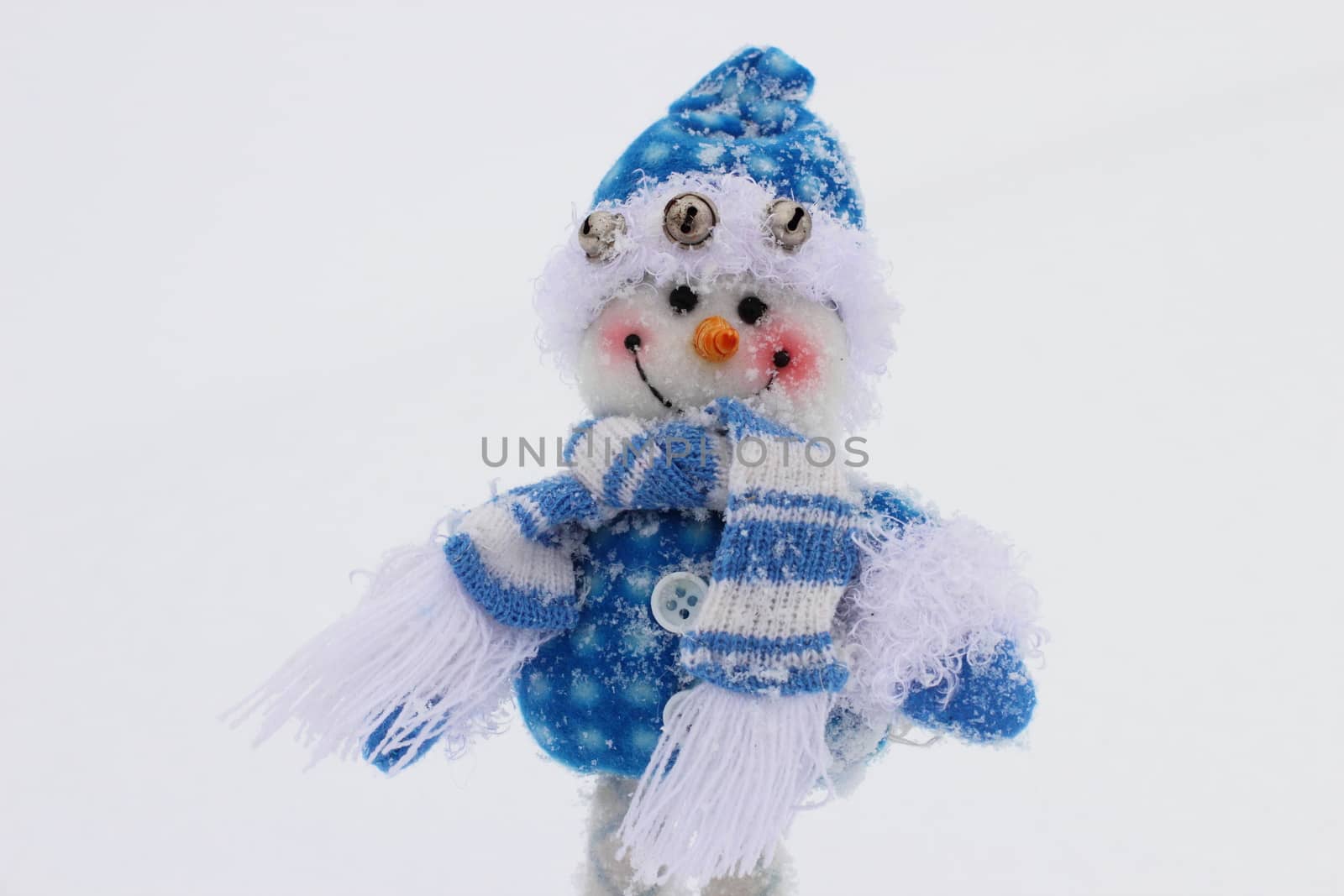 toy snowman in the street in winter clothes