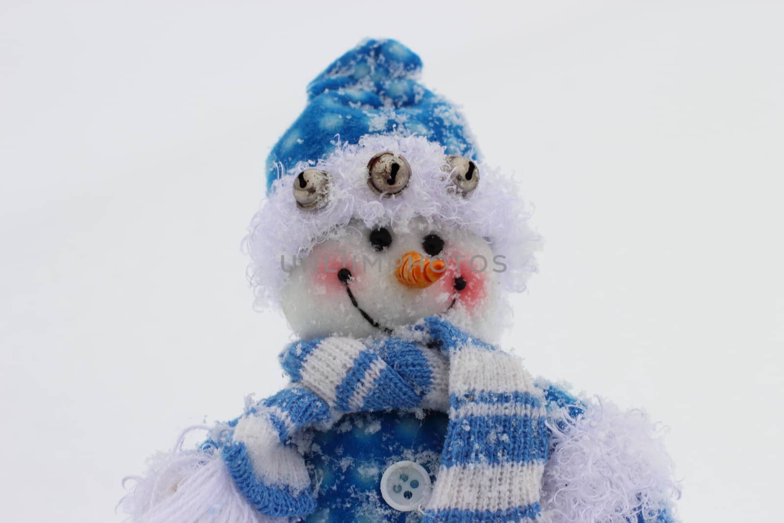 toy snowman in the street in winter clothes