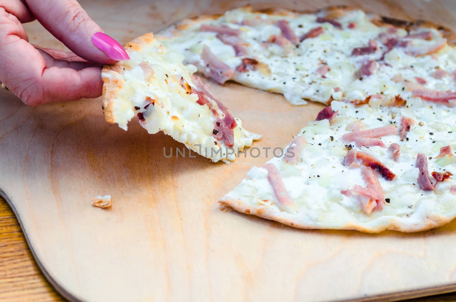 The Tarte is called German Pizza has a very thin crust. But is probably more from the French territory.
In the Alsace region of France, he is often served as an appetizer.