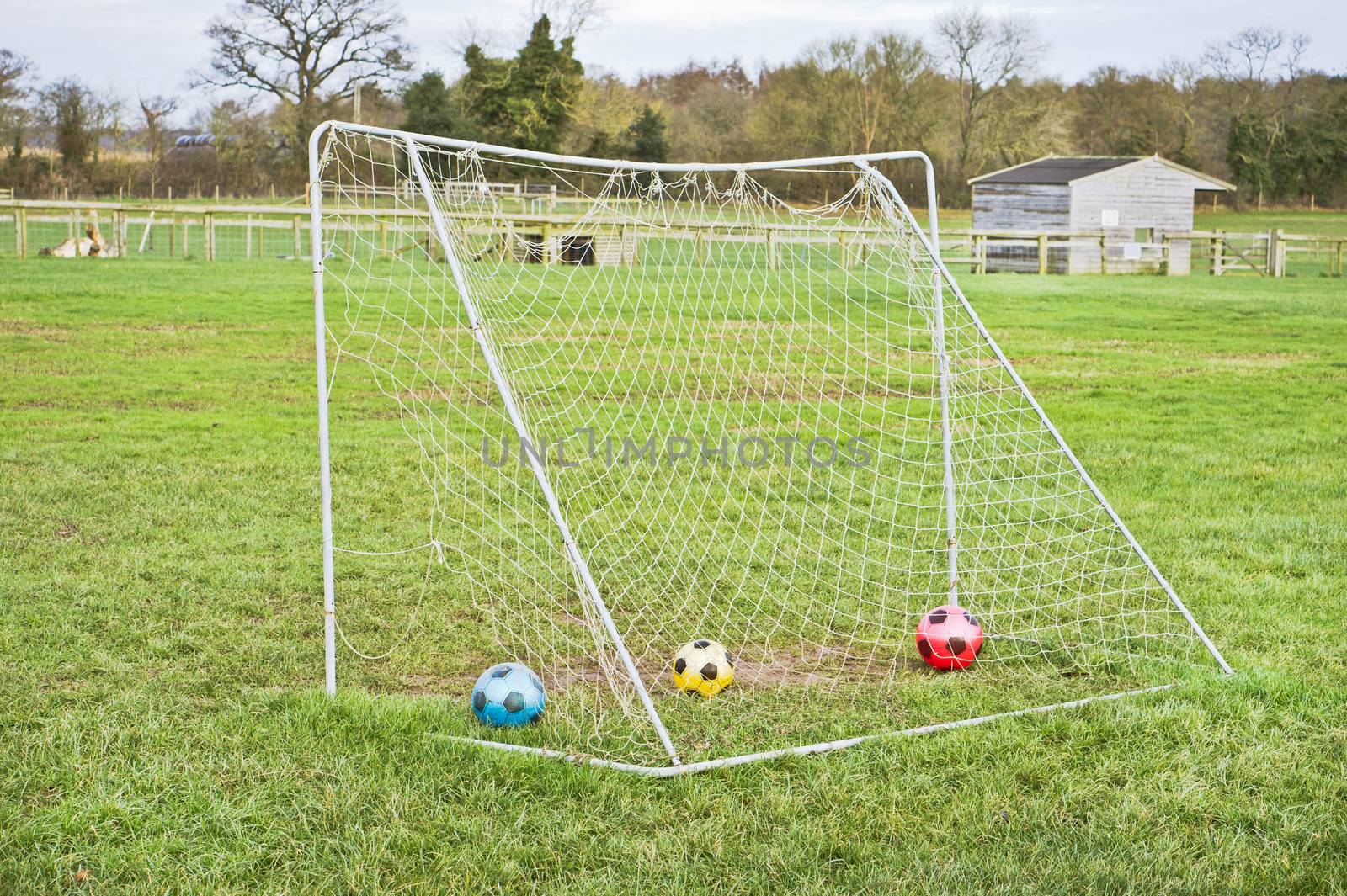 Football goal with colorful balls in it