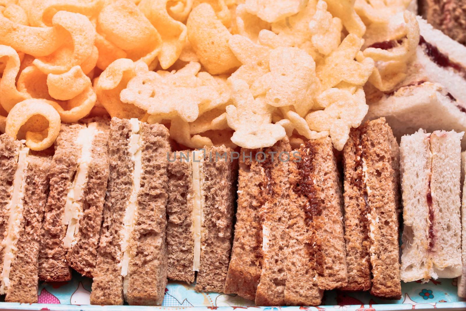 Cheese sand wiches and crisps on a plate